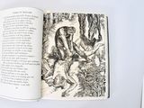 an open book with a picture of a man and a woman in the woods