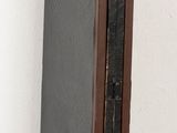 a tall mirror sitting on top of a wooden shelf