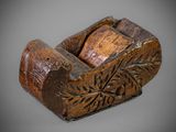 an old wooden plane with a carved design on the side