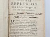 an old book with a black writing on it sitting on a table