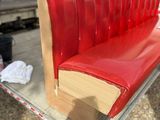 a red bench made out of a book on a trailer
