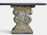 a table with a marble top and a statue on top of it
