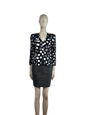 the mannequin is wearing a black and white dress with polka dots on it