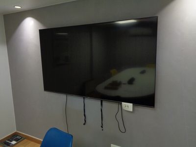 un téléviseur à écran plat fixé au mur d'une pièce