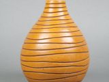 an image of a wooden vase on a gray surface