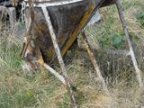 an old boat that is sitting in the grass