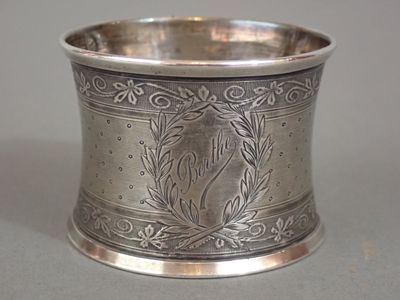 a silver cup with a horse on it on a table