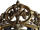 a mirror with a gold frame with flowers and leaves on it