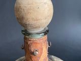 an old bottle with a wooden stopper on top of it