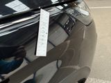 a sticker on the hood of a car that is parked on the side of the road