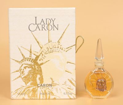 an image of a bottle of lady caron perfume next to a box