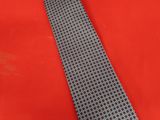 a close up of a tie on a red surface