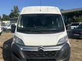 a white van parked in a parking lot next to other cars