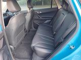 the back seats of a blue car are empty in the car