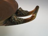 a close up of a metal bowl with a handle