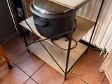 a toaster and a microwave on a stand in a kitchen