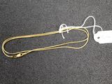 a white tag attached to a yellow cord on the ground