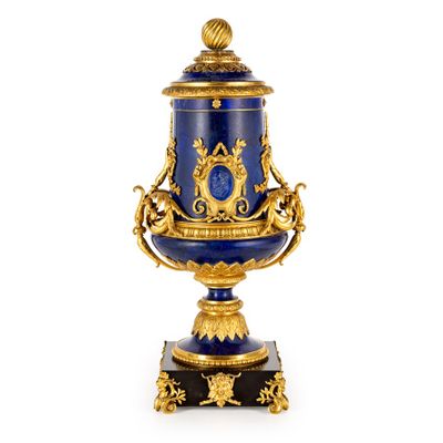 an image of a blue and gold urn with a bird on top