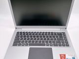 a silver laptop computer sitting on a white surface