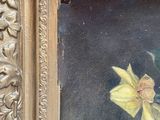 a picture of a painting of a yellow flower in a gold frame