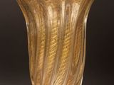 a glass vase that is sitting on a wooden table