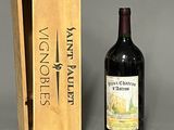 a bottle of wine sitting next to a wooden box