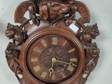 a clock that is hanging on the wall next to a vase