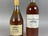 two bottles of wine sitting next to each other on a table