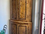 a large wooden cabinet in the corner of a room