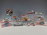 many different models of cars in display cases on a table