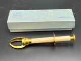 an image of a gold and white pipe with a box in the background