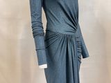 the mannequin is wearing a gray dress with long sleeves