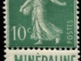 a green and white stamp with a woman on it