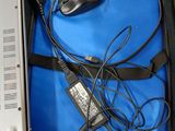 a laptop and a mouse in a case on a table
