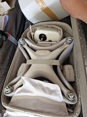 a person opening a suitcase with a camera inside of it