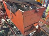 a rusted metal box sitting in the middle of a pile of junk