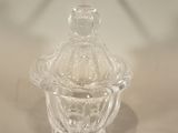 a clear glass jar with a lid on a table