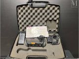 a suitcase that has a camera and other items in it