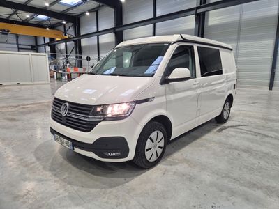 the white van is parked in a large warehouse with its roof open