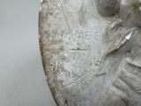 a close up of a silver coin with a woman on it