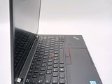 a black laptop with a red button on the keyboard