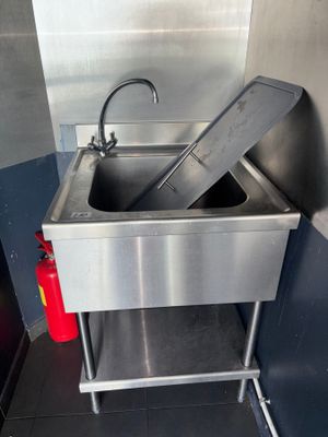 a sink with a fire extinguisher next to it