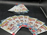 several packs of pokemon trading cards are on a black table