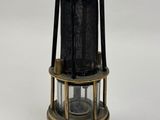 a close up of a metal and glass light fixture on a white surface