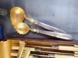 a gold spoon and a silver spoon in a case