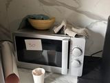 a microwave and a cup on a counter in a kitchen