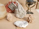 a table with a clock and some rocks on it