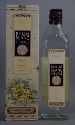 bottle of rum blanc agroulle next to a map of the world