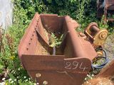 a rusted piece of machinery that is sitting in the grass