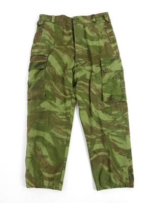 a close up of a green camouflage cargo pants on a white background
